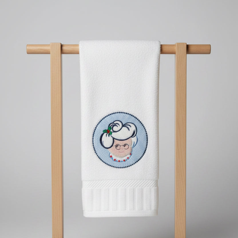 White towel with embroidered design of Mrs. Clause