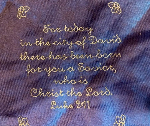 Nativity tree skirt with a blue background.