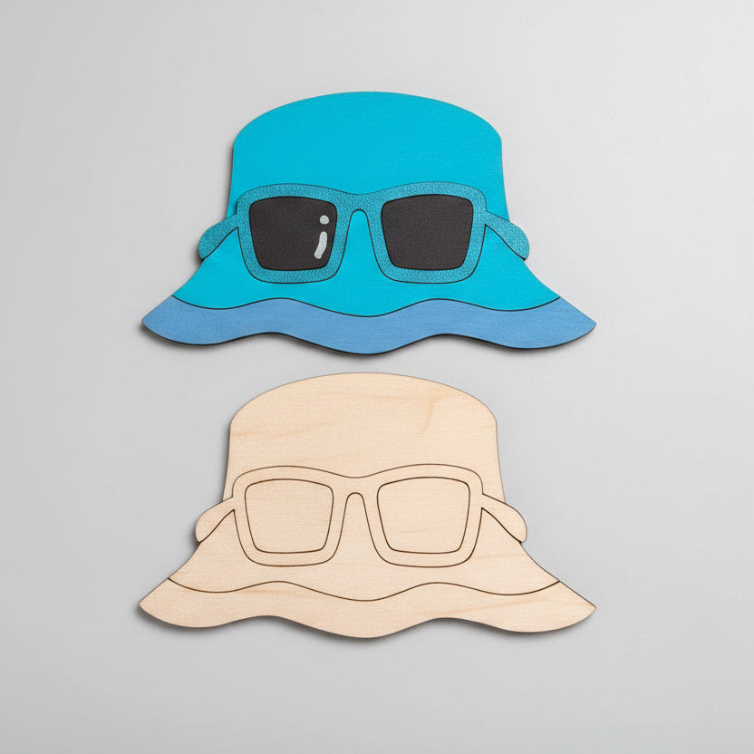 Two MDF cutouts of a blue bucket hat and an unpainted bucket hat