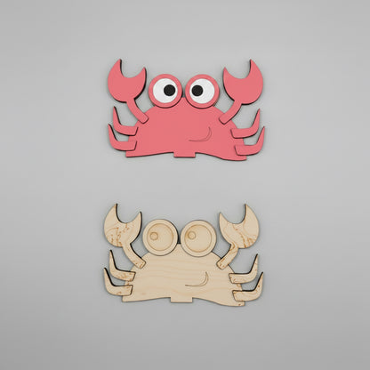 Two crab-shaped MDF cutouts, one red and one unpainted