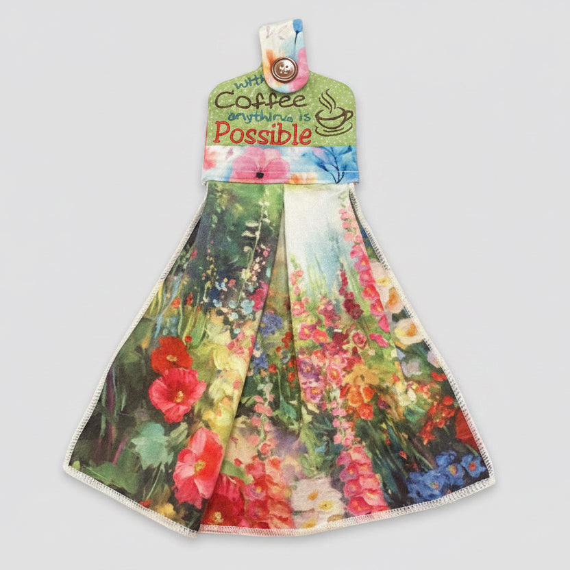 Floral-patterned dish towel with text "with coffee anything is possible"
