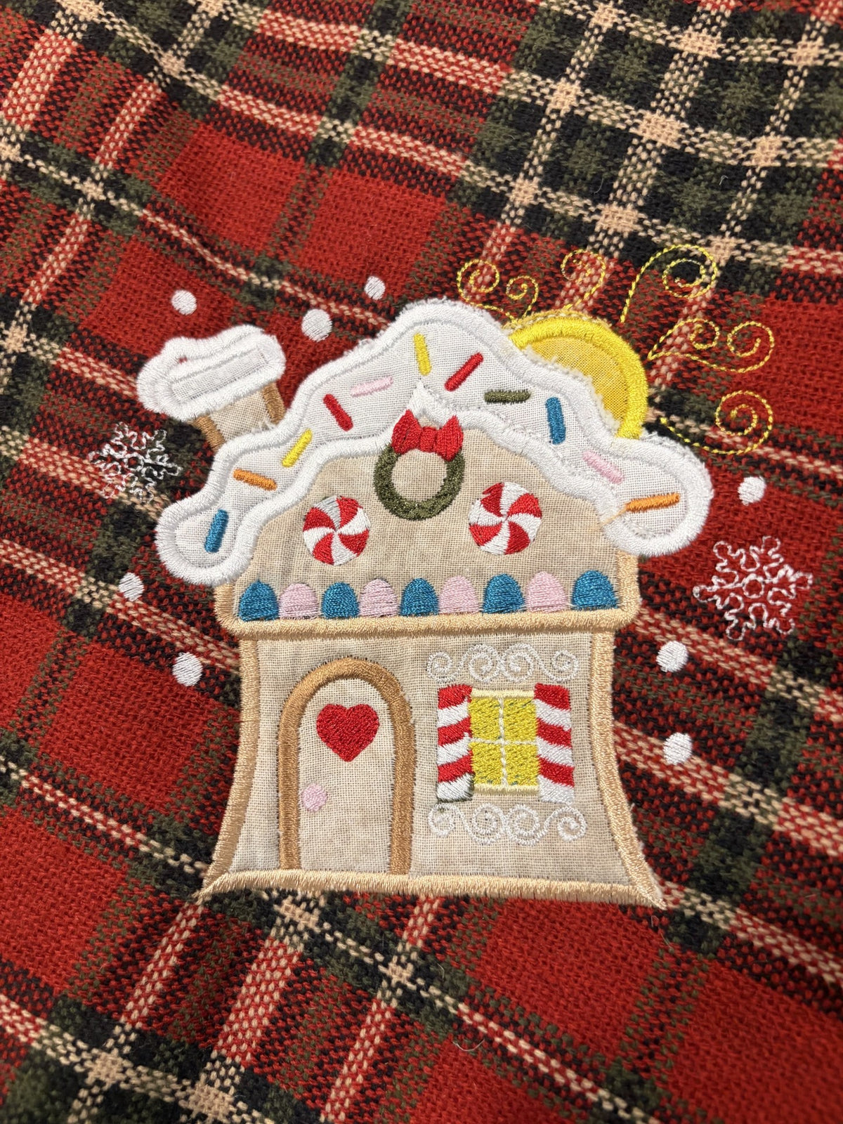 Gingerbread Tree skirt with a Christmas plaid background and green satin ruffle.
