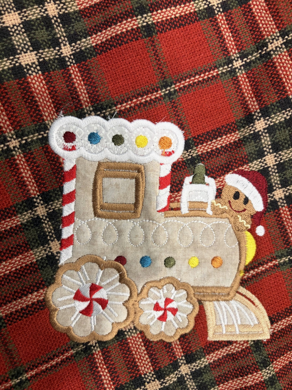 Gingerbread Tree skirt with a Christmas plaid background and green satin ruffle.