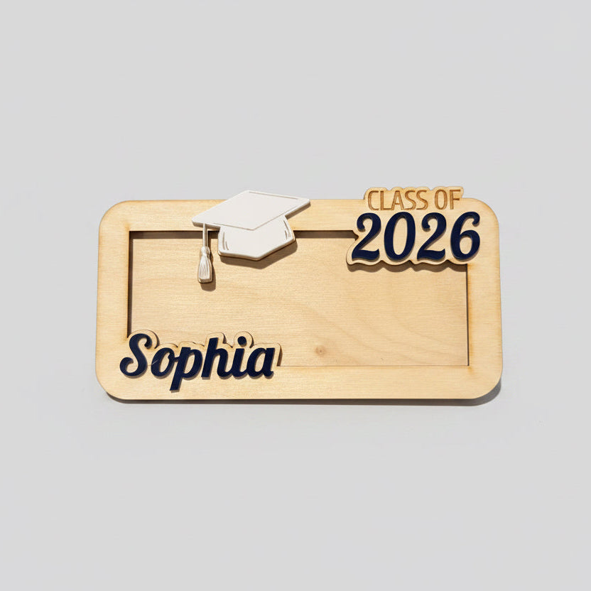 A wood money holder for graduates that has a graduation hat, the graduate's name, and "Class of 2026" in custom colors