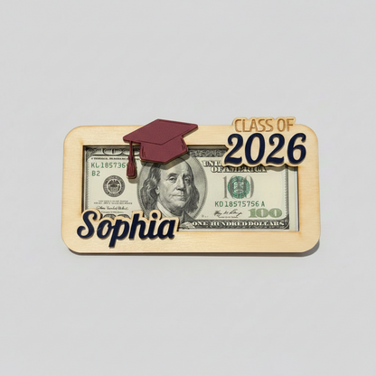 A wood money holder for graduates that has a graduation hat, the graduate's name, and "Class of 2026" in custom colors