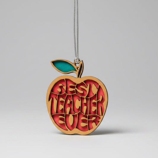 Wooden apple-shaped ornament with 'Best Teacher Ever' text on a beige background