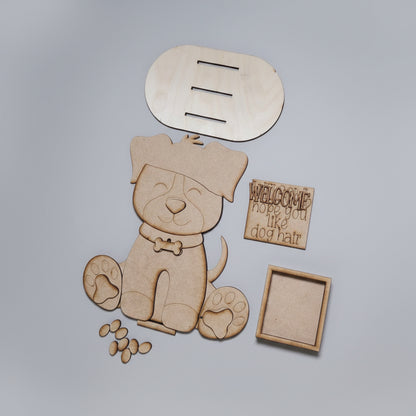 Wooden dog cutout with paw prints and a speech bubble on a brown surface.