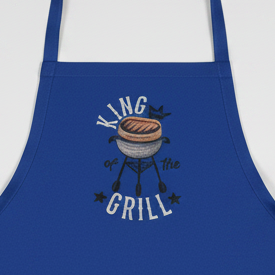 Blue apron with 'King of the Grill' design on a white background