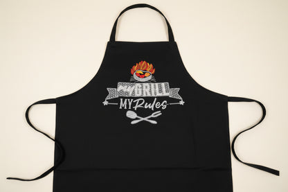Black apron with embroidered design of a grill, text 'my GRILL MY Rules', and grill utensils