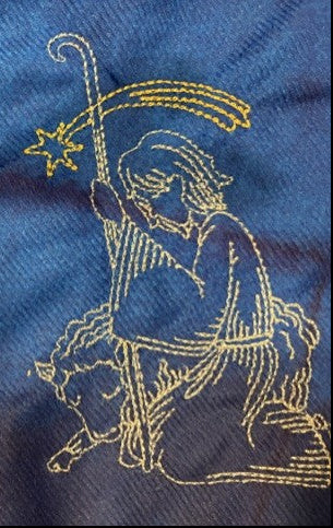 Nativity tree skirt with a blue background.