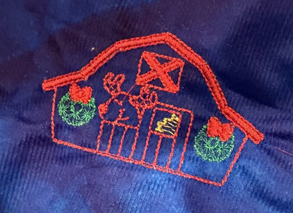 Northpole Village tree skirt with a sketch style embroidery on a blue background.