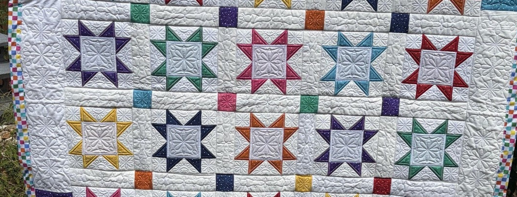 Prairie Star Quilt with intricate embroidery highlights