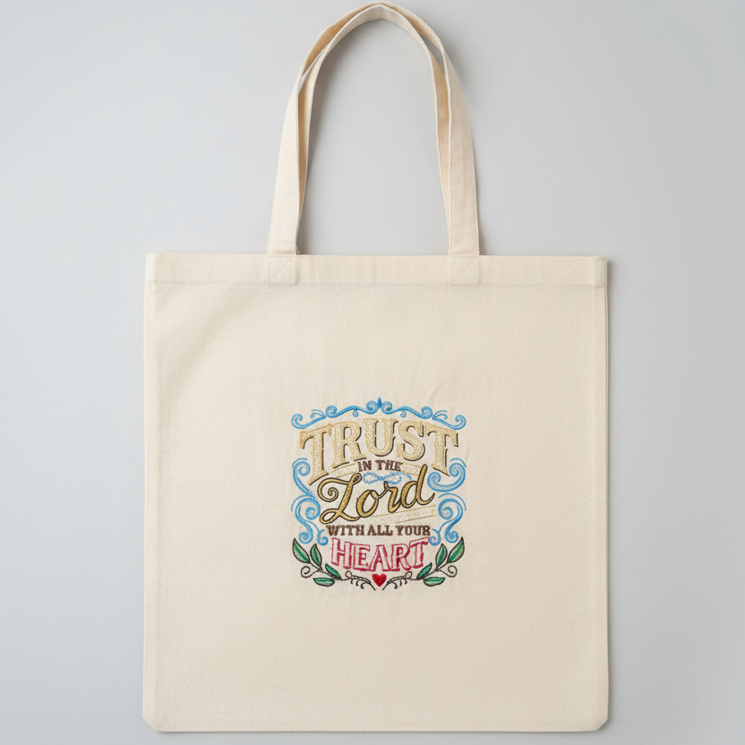 Tote bag with 'Trust in the Lord with all your heart' text on a gray background