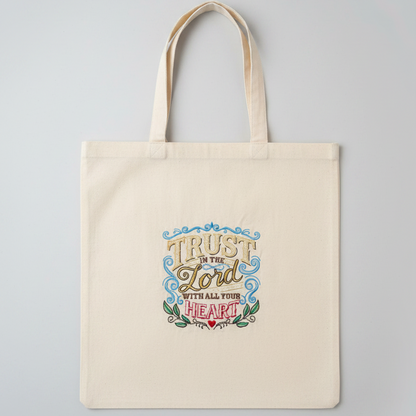 Tote bag with 'Trust in the Lord with all your heart' text on a gray background