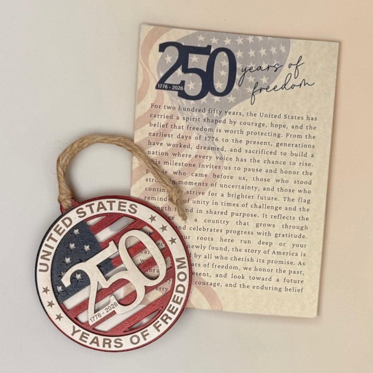 Decorative ornament with 'United States 250 years of freedom' text and American flag design on a plain background with a story card about the significance of the occasion.
