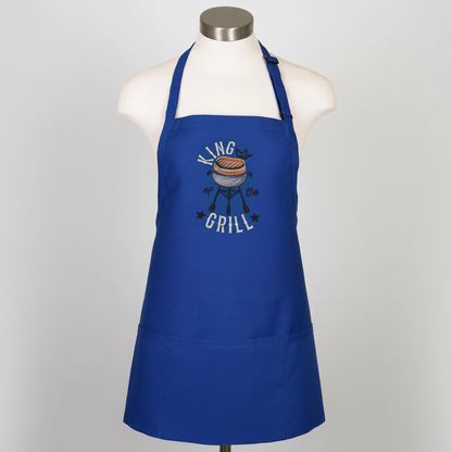 Blue apron with 'King of the Grill' graphic on a mannequin against a white background