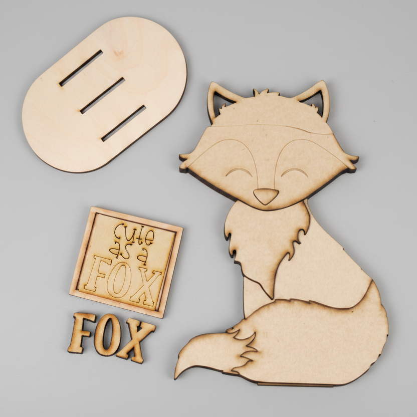 Wooden fox cutout with 'The Fox' text on a white background