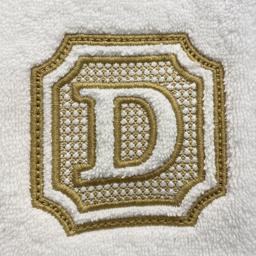 Embroidered letter 'D' on a white towel