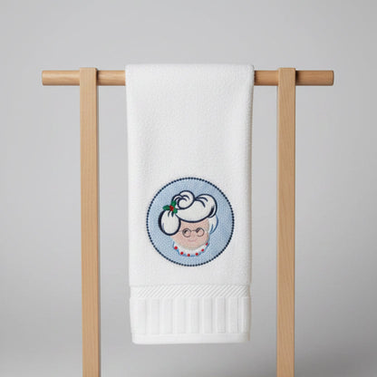 White towel with embroidered design of Mrs. Clause