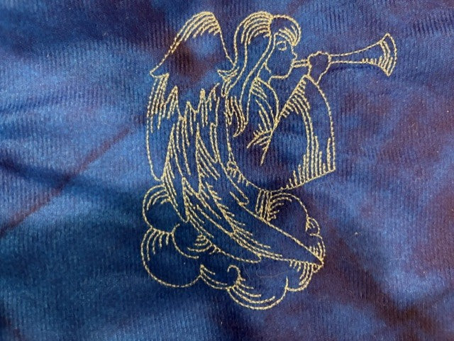 Nativity tree skirt with a blue background.