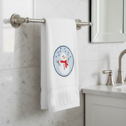 Towel with a snowman design hanging on a towel rack in a bathroom.