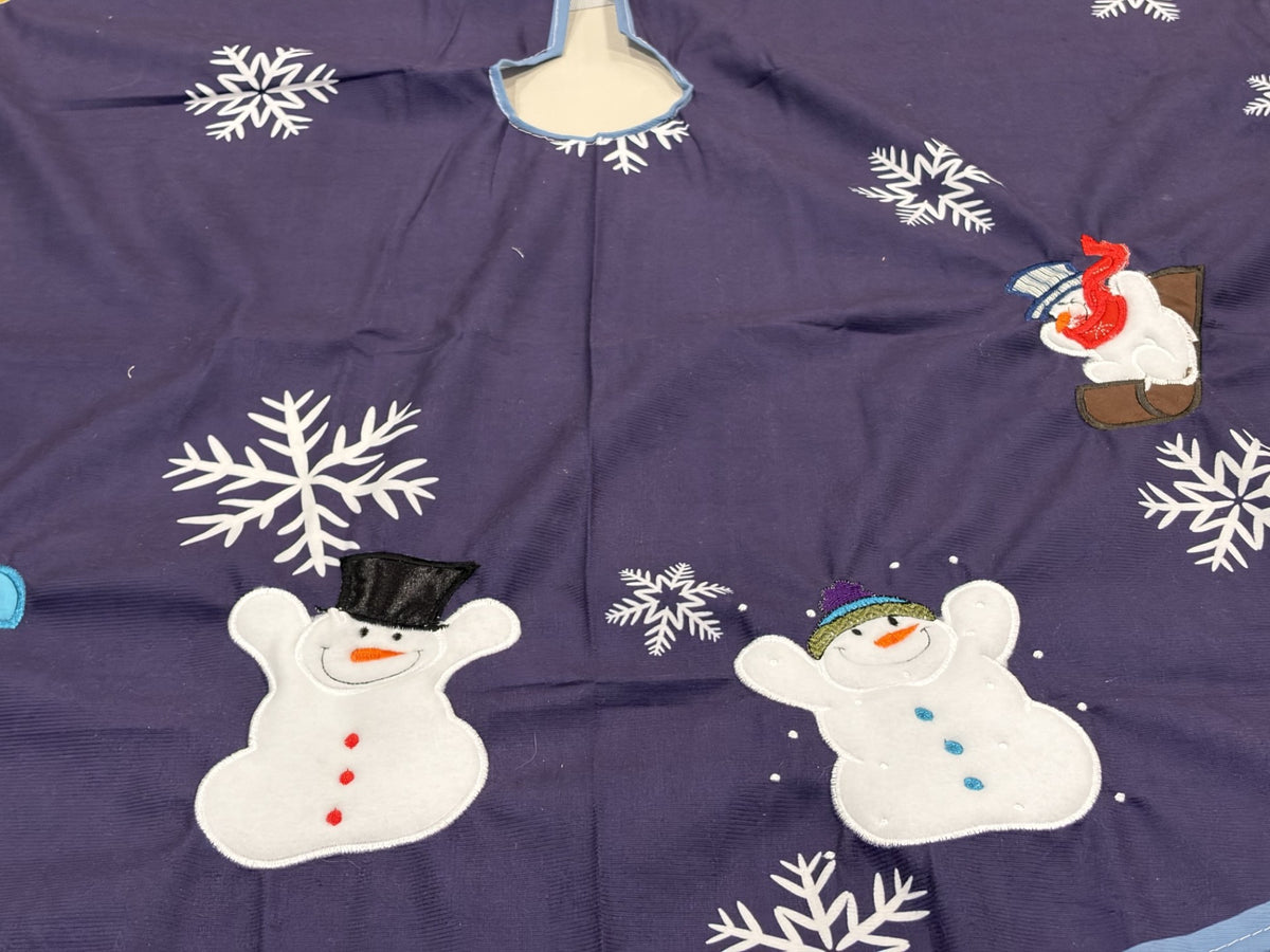 Snowmen tree skirt with applique embroidery on a blue background.