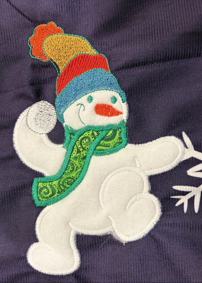 Snowmen tree skirt with applique embroidery on a blue background.